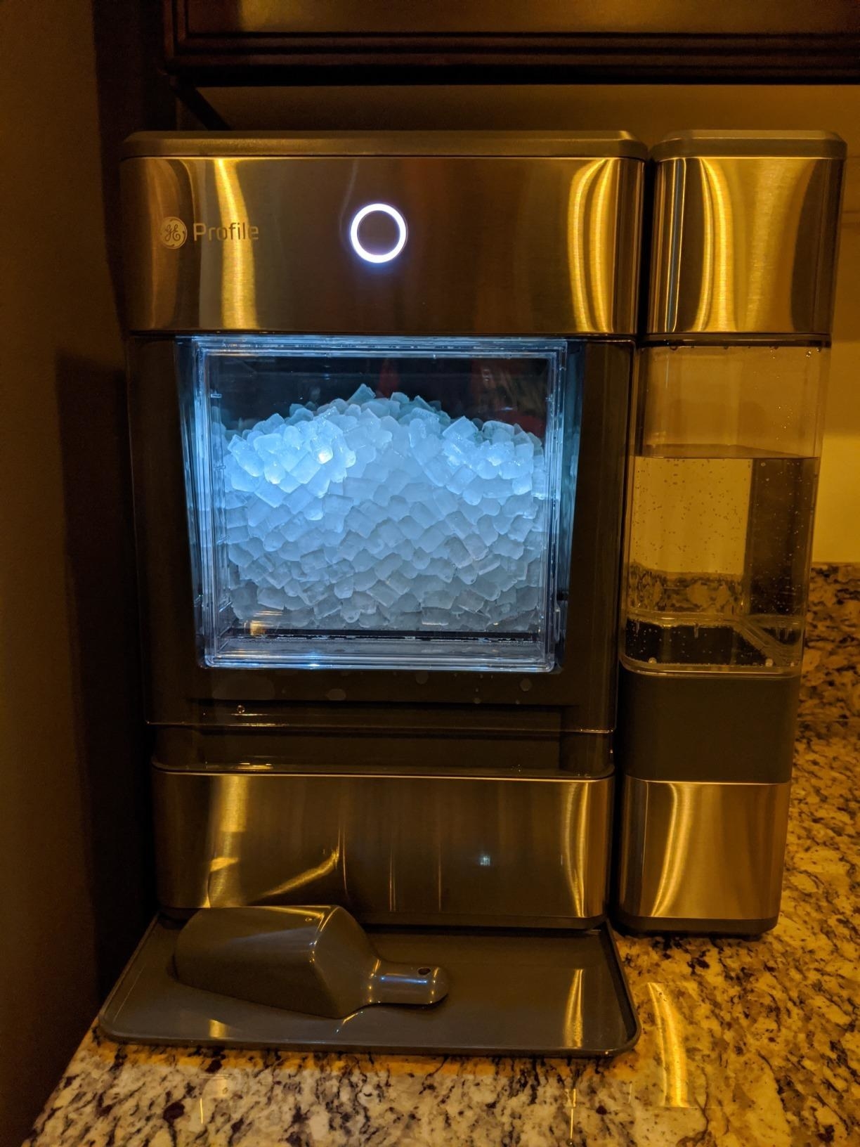 the ice maker filled with ice on a counter