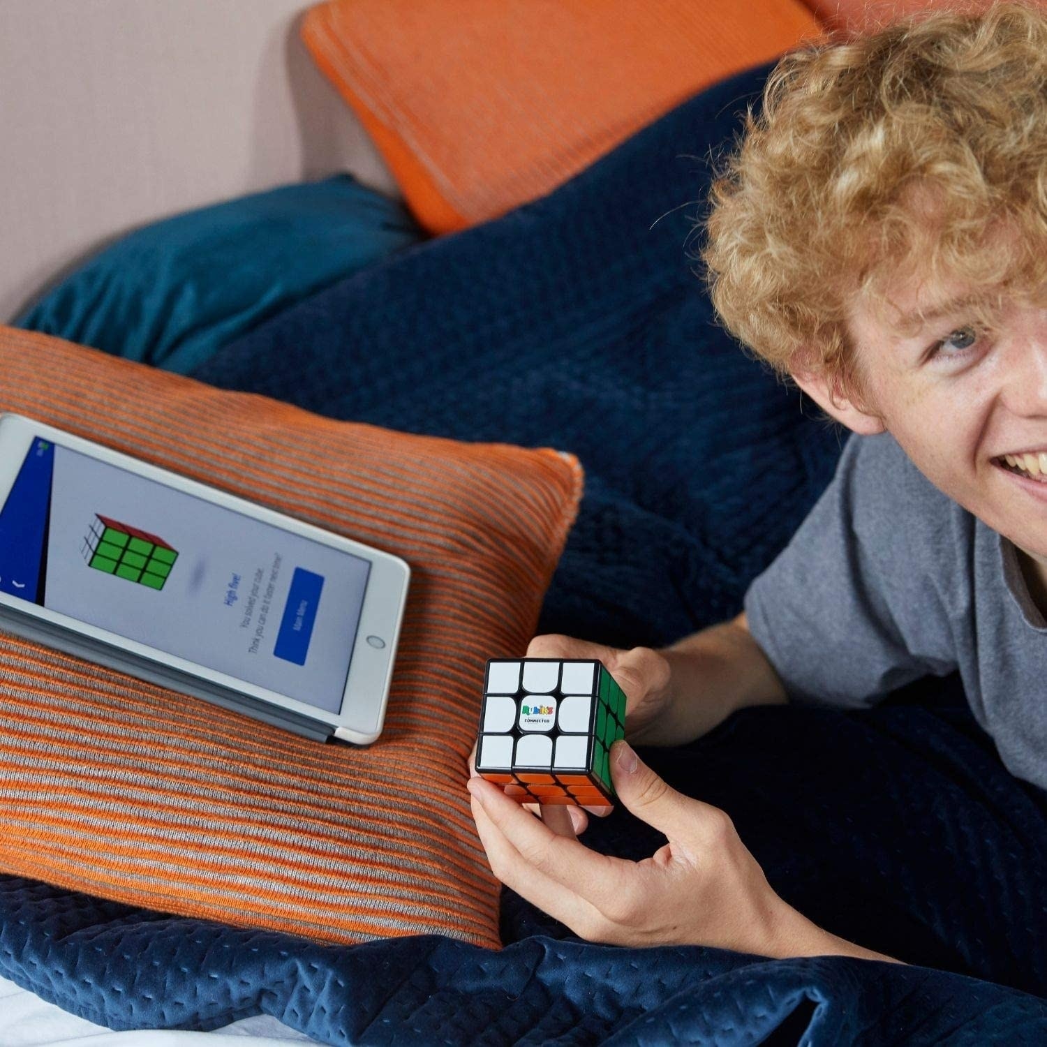 A person solving the cube with the app on their tablet in front of them