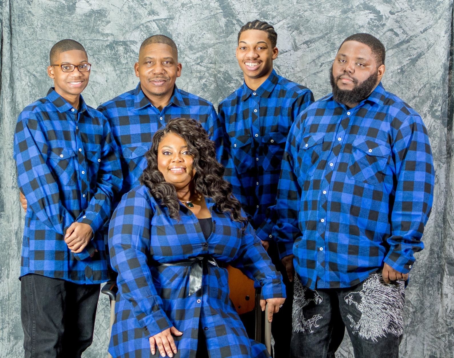 a reviewer group all wearing the plaid shirts in blue and black plaid