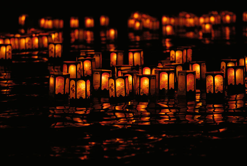 Lanterns floating in a lake, at sunset, for the Lantern Floating Festival in Hawaii