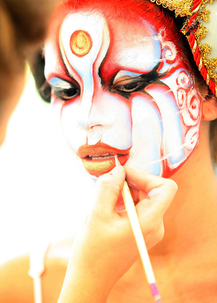 A woman gets her face painted at the World Bodypainting Festival in Austria