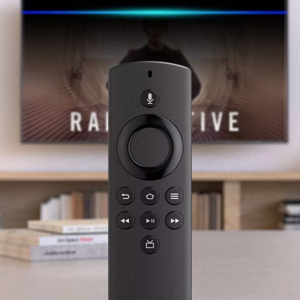 Black Amazon Fire Stick remote in front of TV