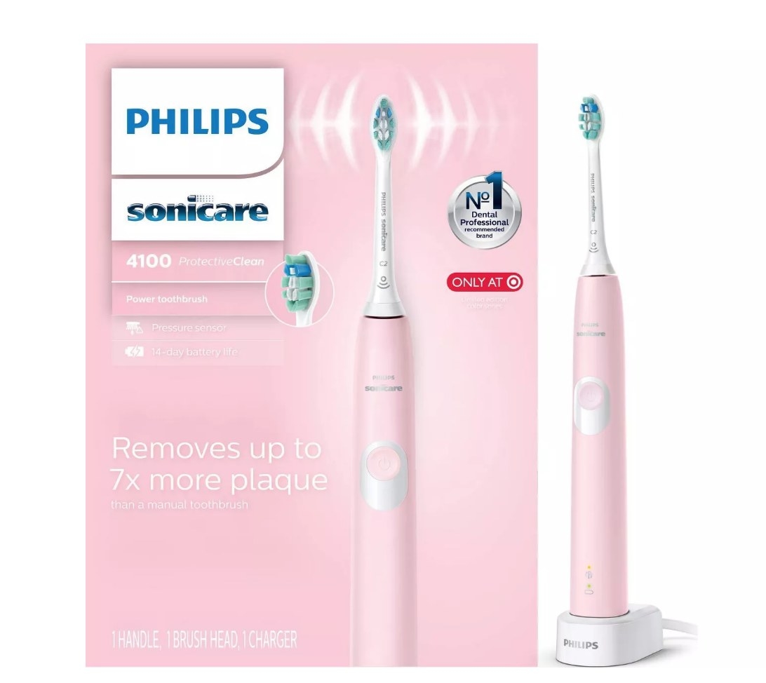 Pink Philips electric toothbrush packaging with pink toothbrush in white charger on right side