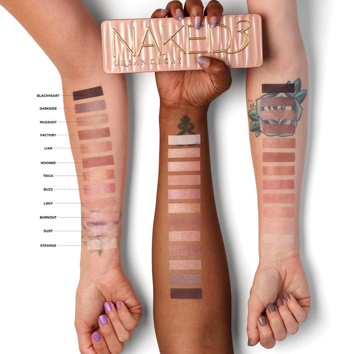 three models wearing the eyeshadow swatches on their forearms