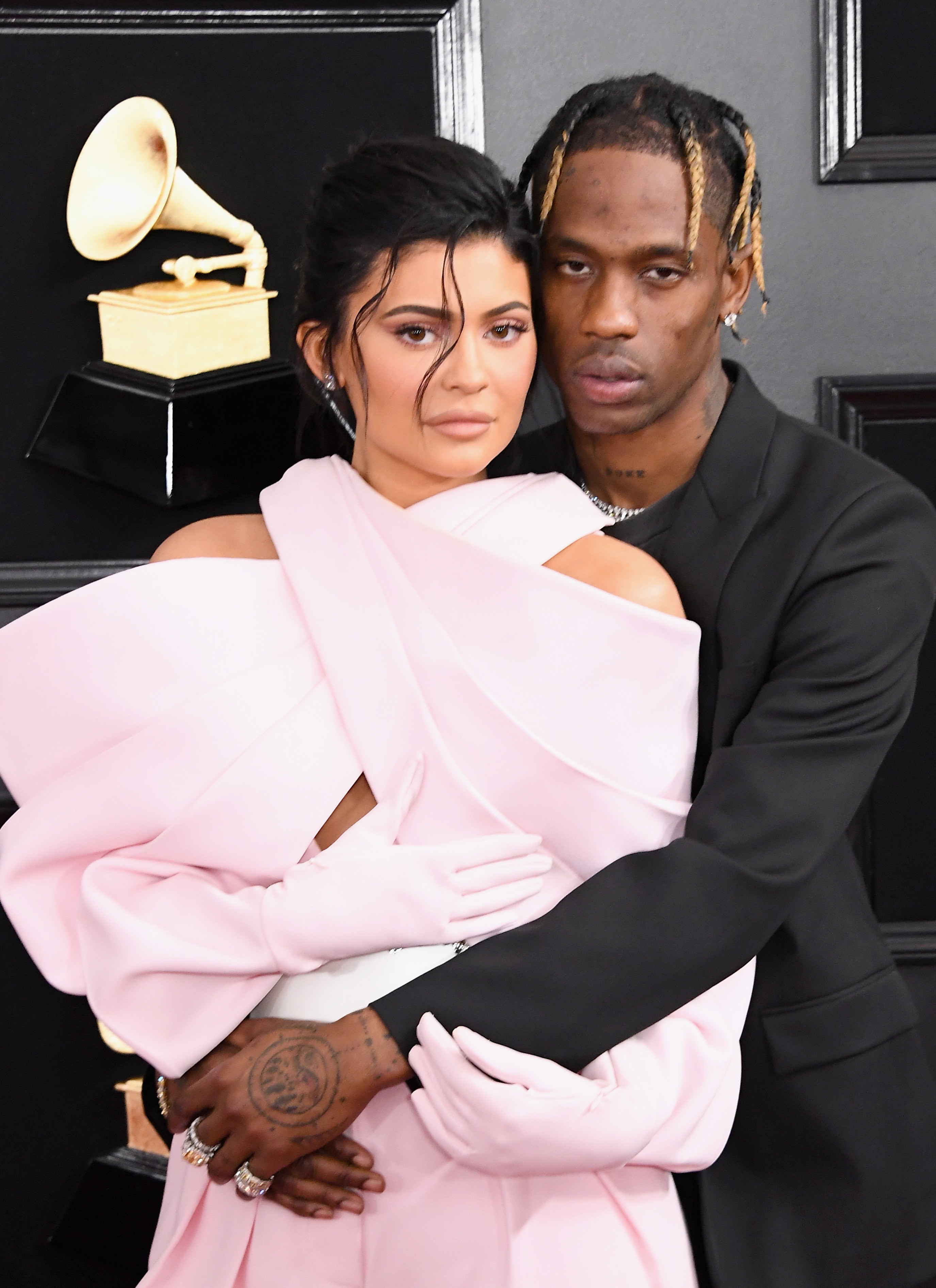 Travis embraces Kylie on the red carpet