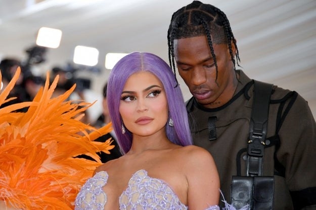 Kylie and Travis stand together