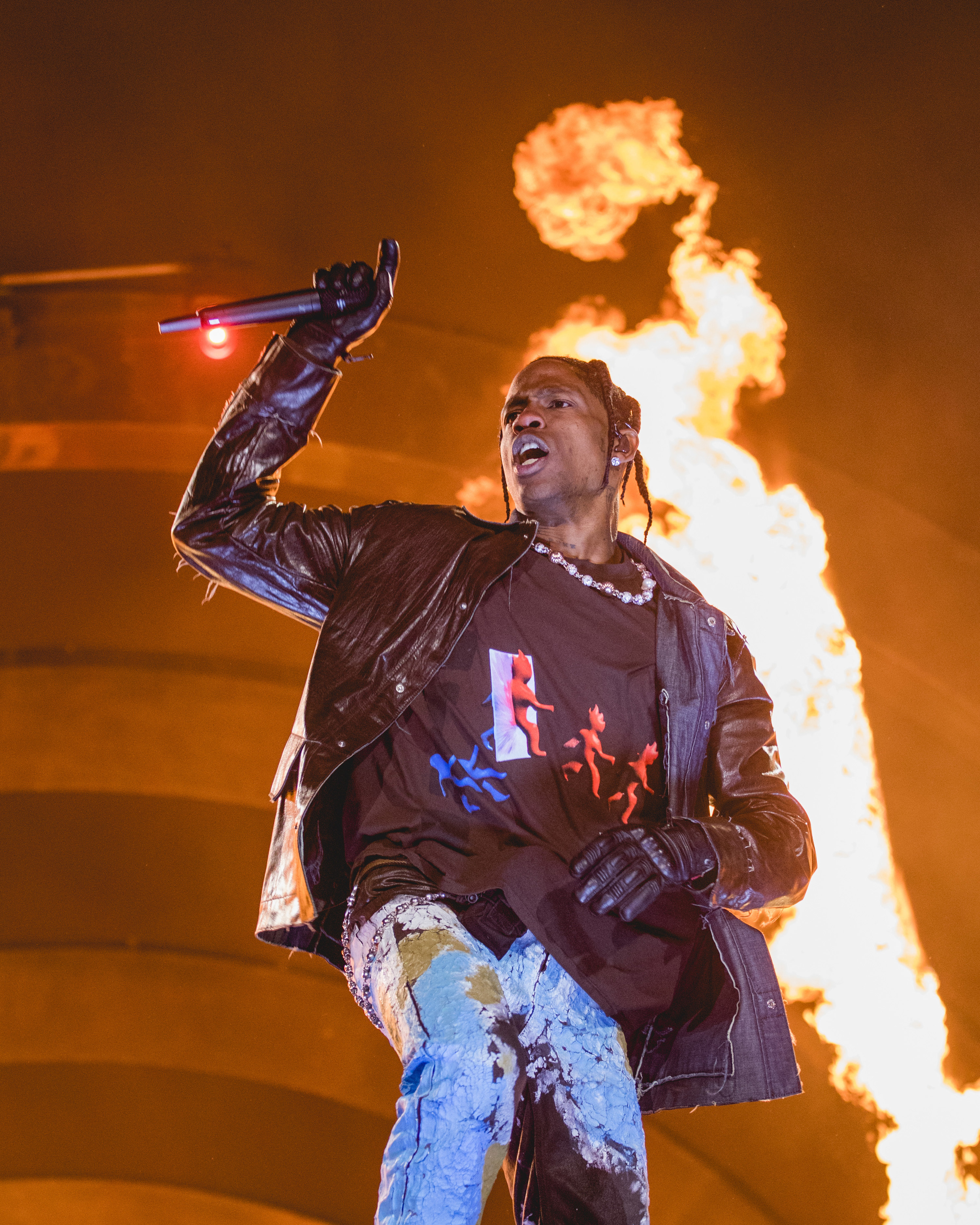 Kylie onstage with flames behind him