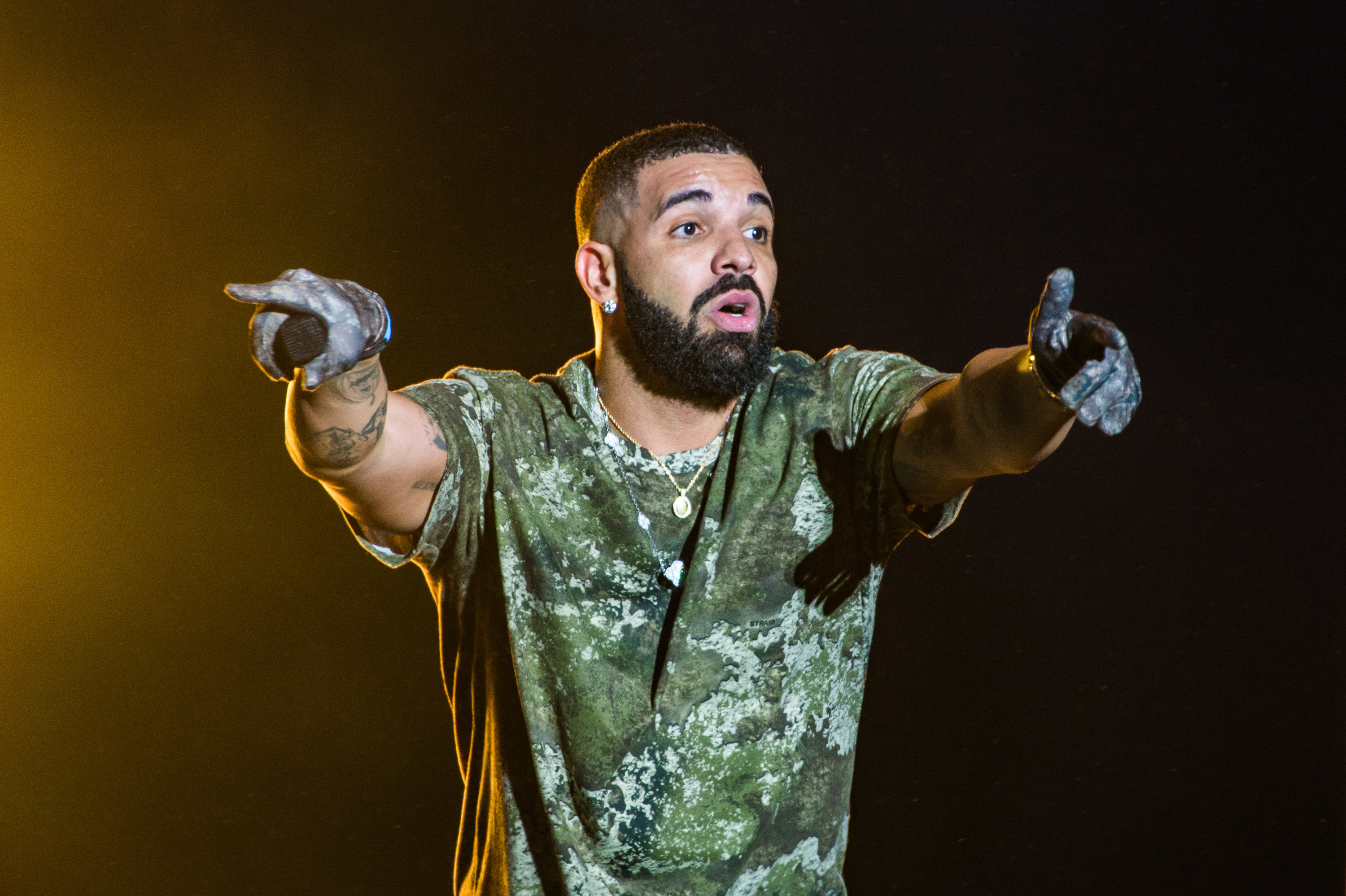 Drake gesturing onstage