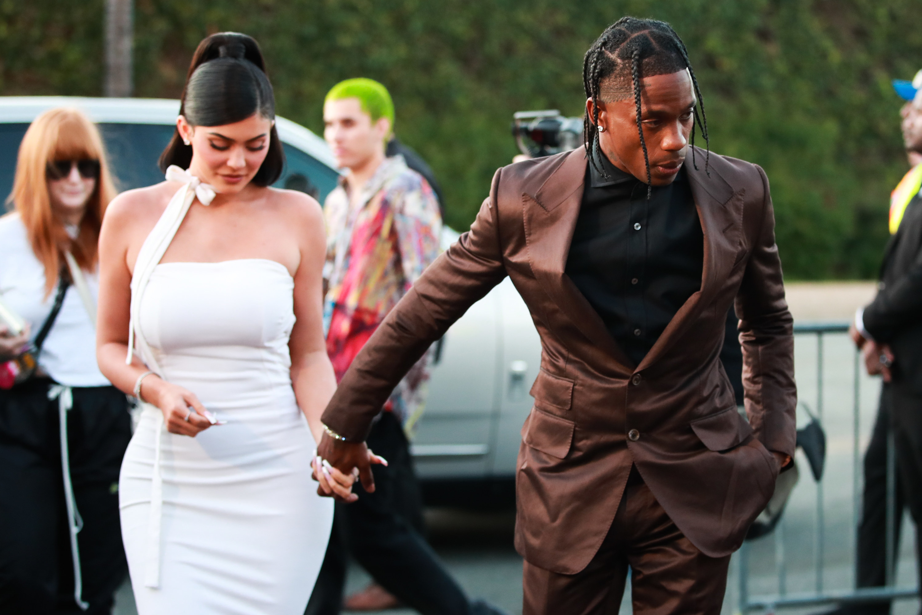 Kylie and Travis hand in hand