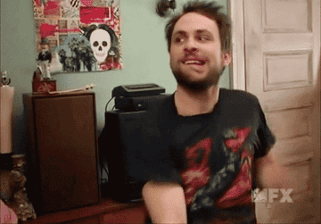 a gif of charlie day excitedly pumping his arms