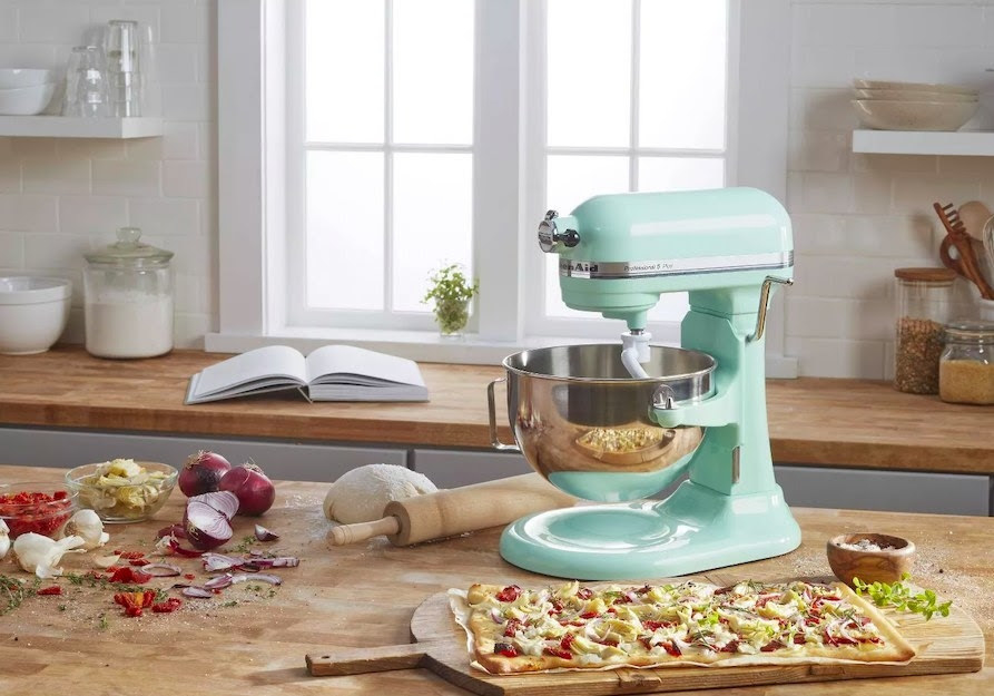 blue KitchenAid stand mixer on counter with veggie pizza