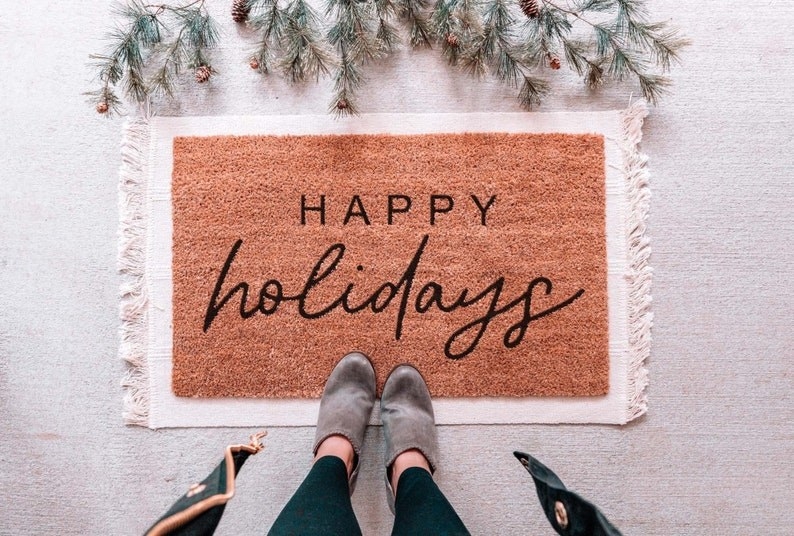 doormat with fringe that says &quot;Happy Holidays&quot; on the front