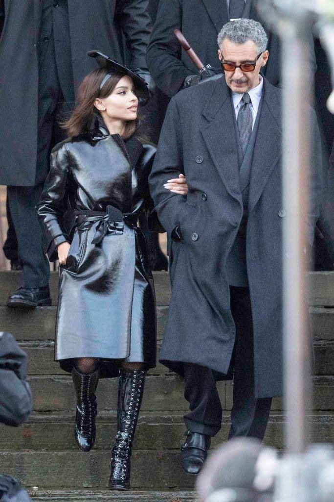 Zoë walking down steps arm-in-arm with John Turturo in a scene from the film