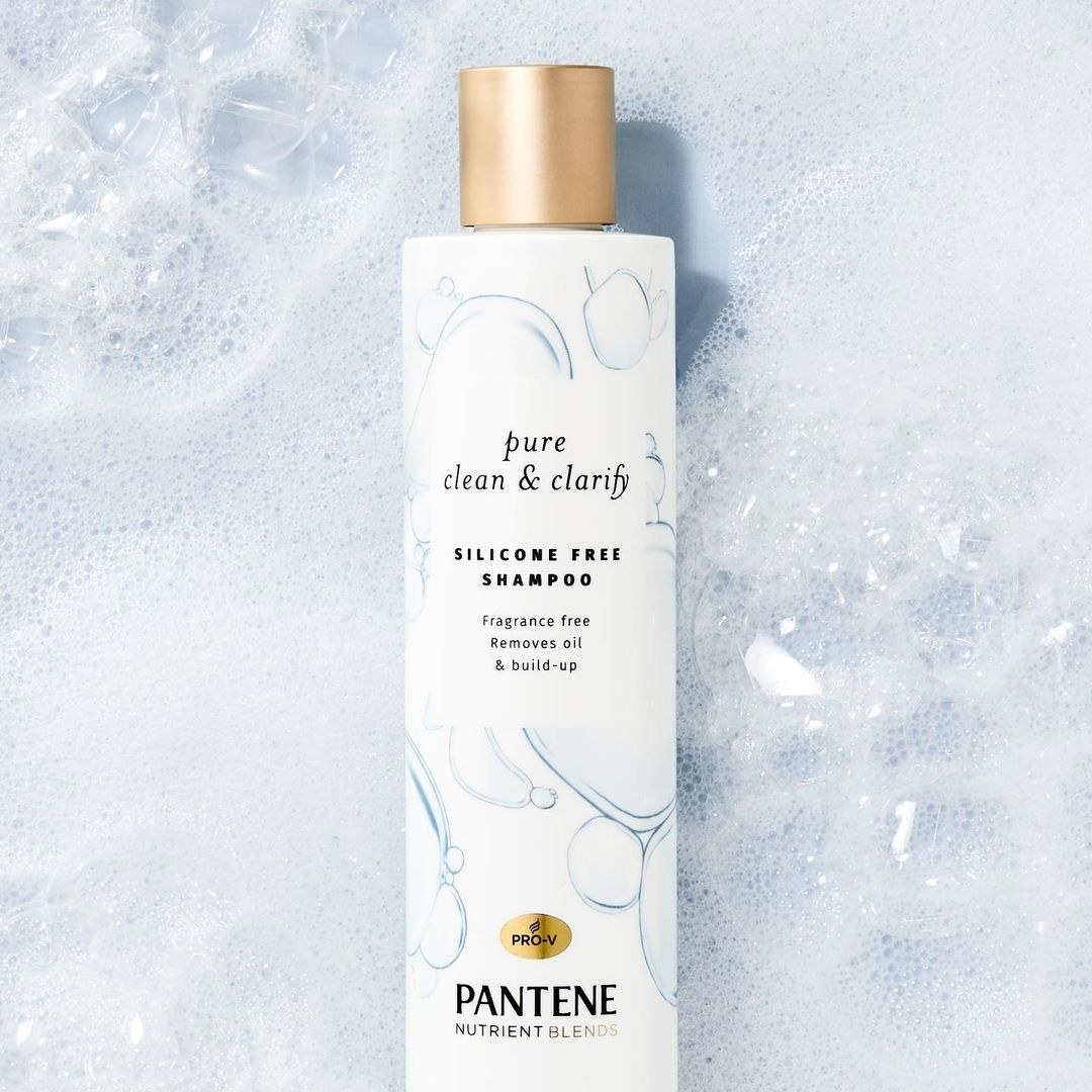 a bottle of the clarifying shampoo on a sudsy background