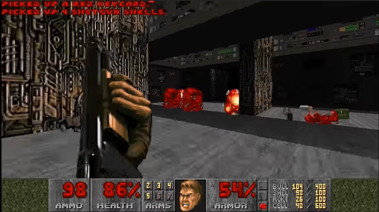 A screenshot of a space marine in Doom killing two enemies with a shotgun