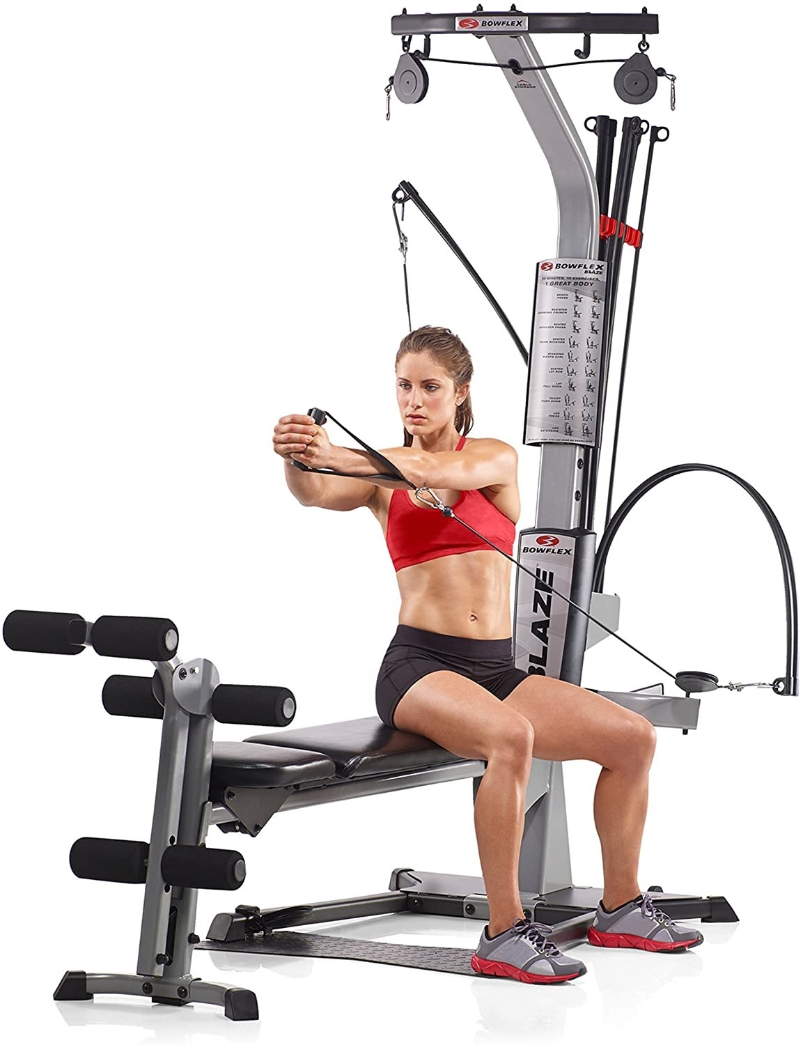 A person using the machine to do an arm pull while sitting on the bench