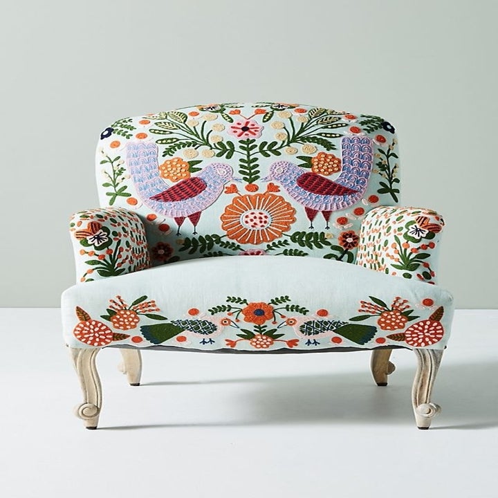 An accent chair with felt embroidery of flowers and birds