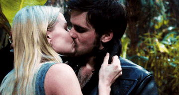 Emma and Hook kiss as Emma holds onto his collar