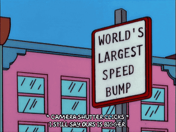 a gif image from the simpsons where a sign reads worlds largest speed bump