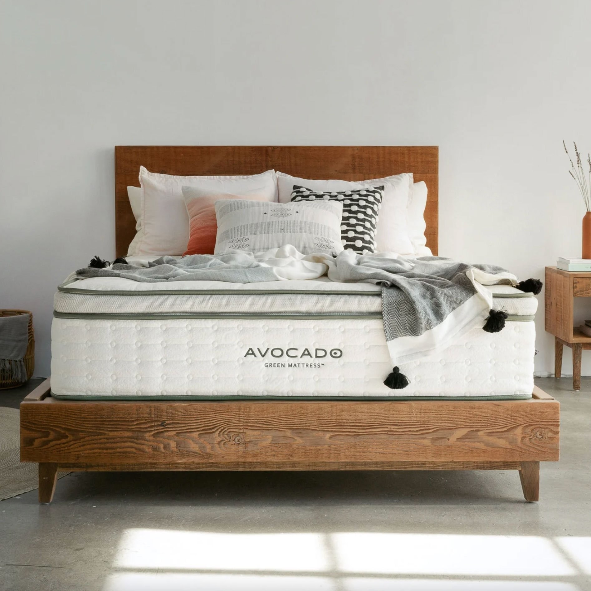 Avocado mattress styled on their wooden platform bed