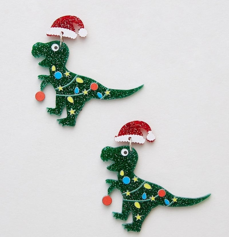 green dinosaurs with santa hats and string lights around their bodies