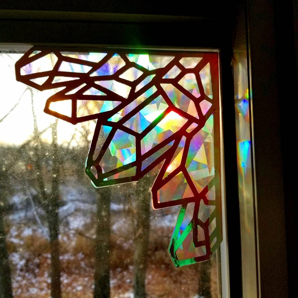 a sticker that fits in the corner of a window and shoots rainbows into the room