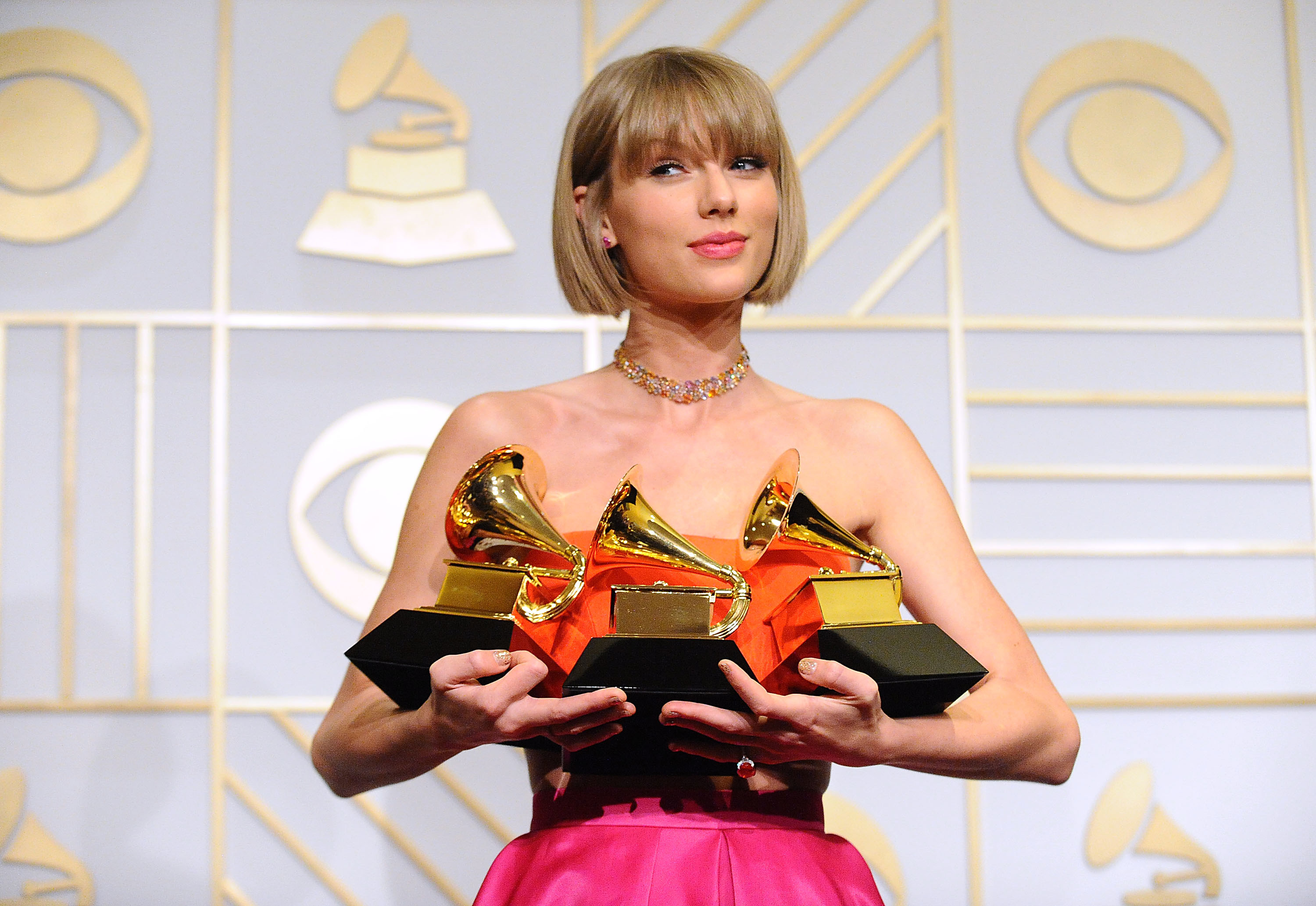 Taylor holding three Grammys
