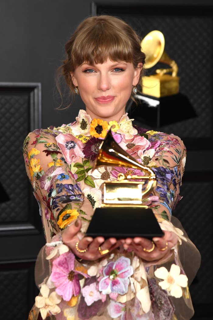 Taylor holding an award