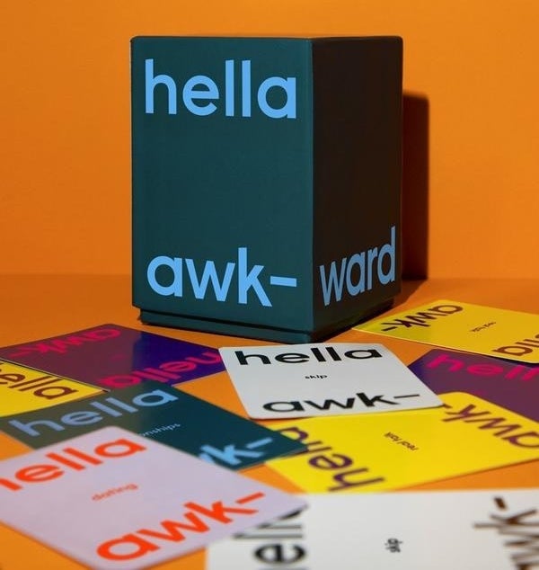 a box that says &quot;hella awkward&quot; surrounded by colorful cards that say the same