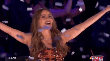 a gif of Sofia Vergara waving their arms as confetti falls on &quot;America&#x27;s Got Talent&quot;