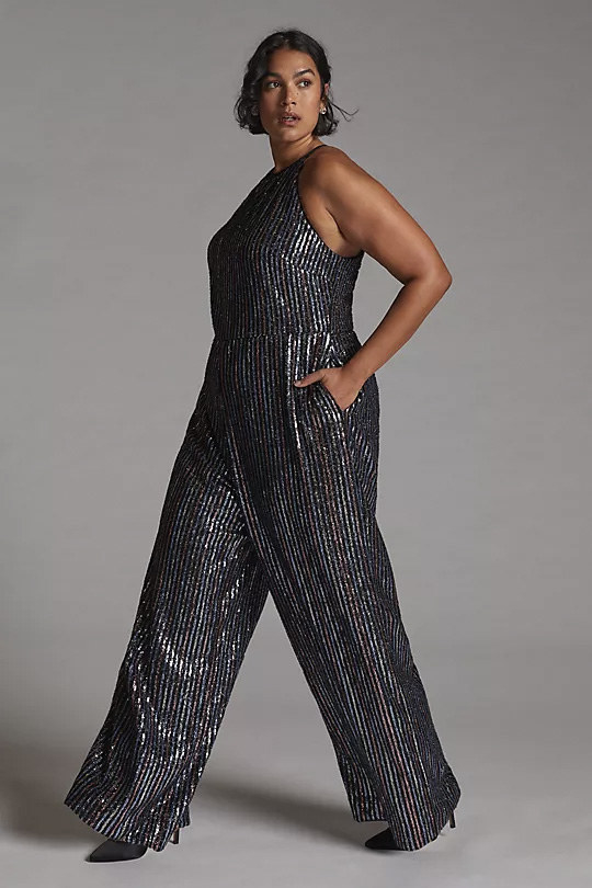 A person wearing a glittery jumpsuit with heels