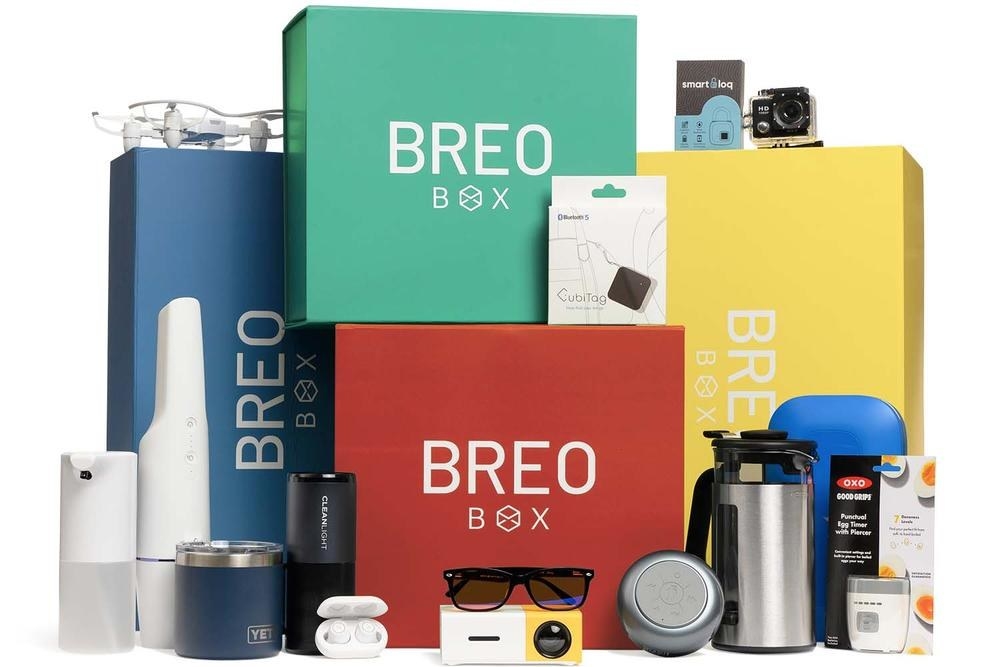 Breo Boxes and products, which include Yeti mugs, Bluetooth speakers, a projector, sunglasses, and more