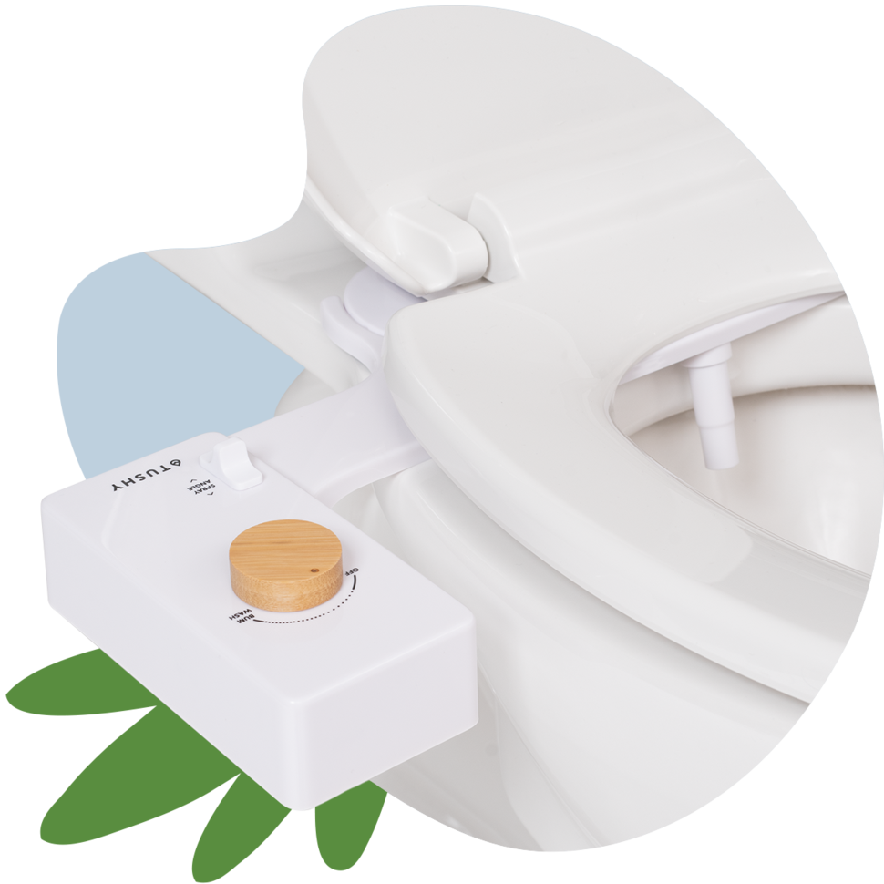 A white bidet attachment with a bamboo knob on a toilet