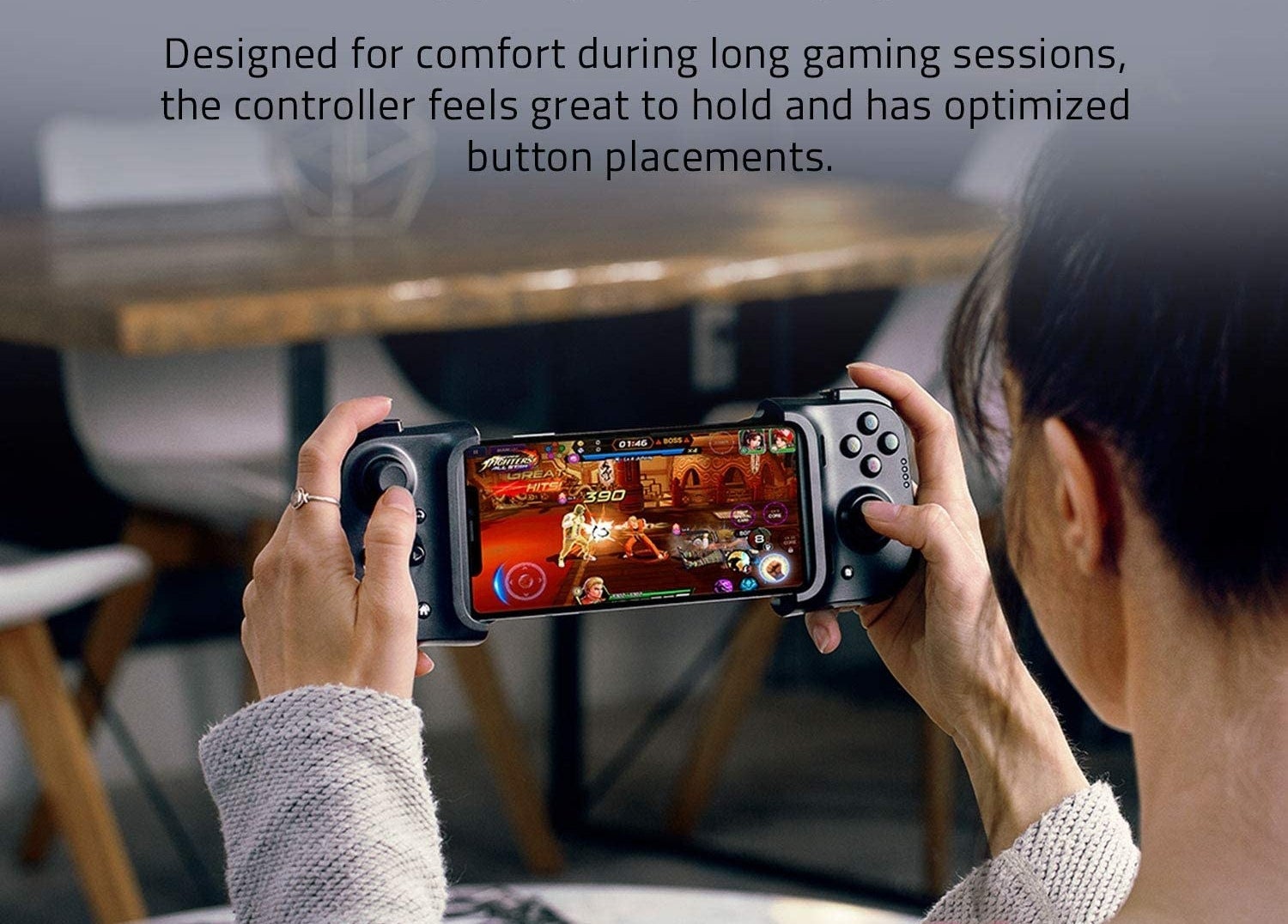a person playing a game with the controller snapped onto their phone