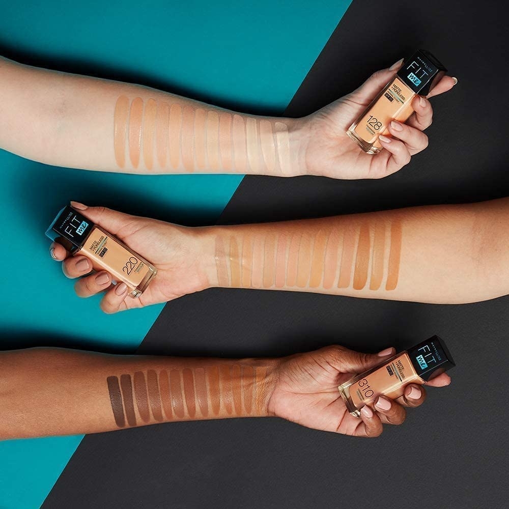 three arms in various skin tones swatching the full collection of foundations