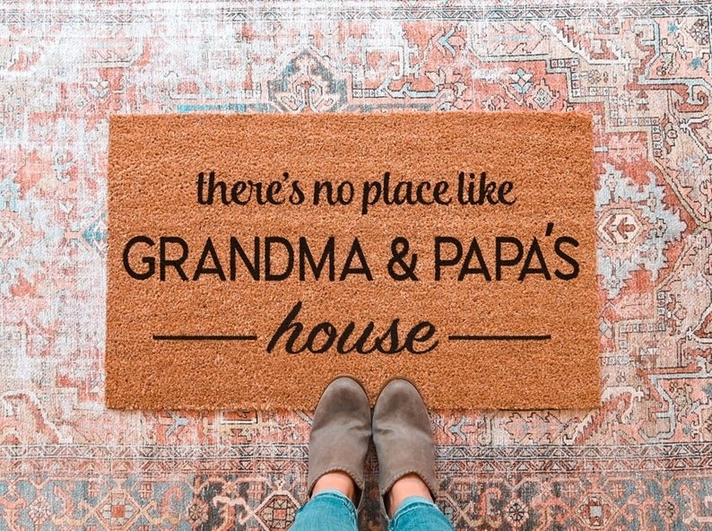 a welcome mat that says "there's no place like grandma and papa's house"