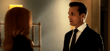 Donna walks toward Harvey, wraps her arms around him, and kisses him