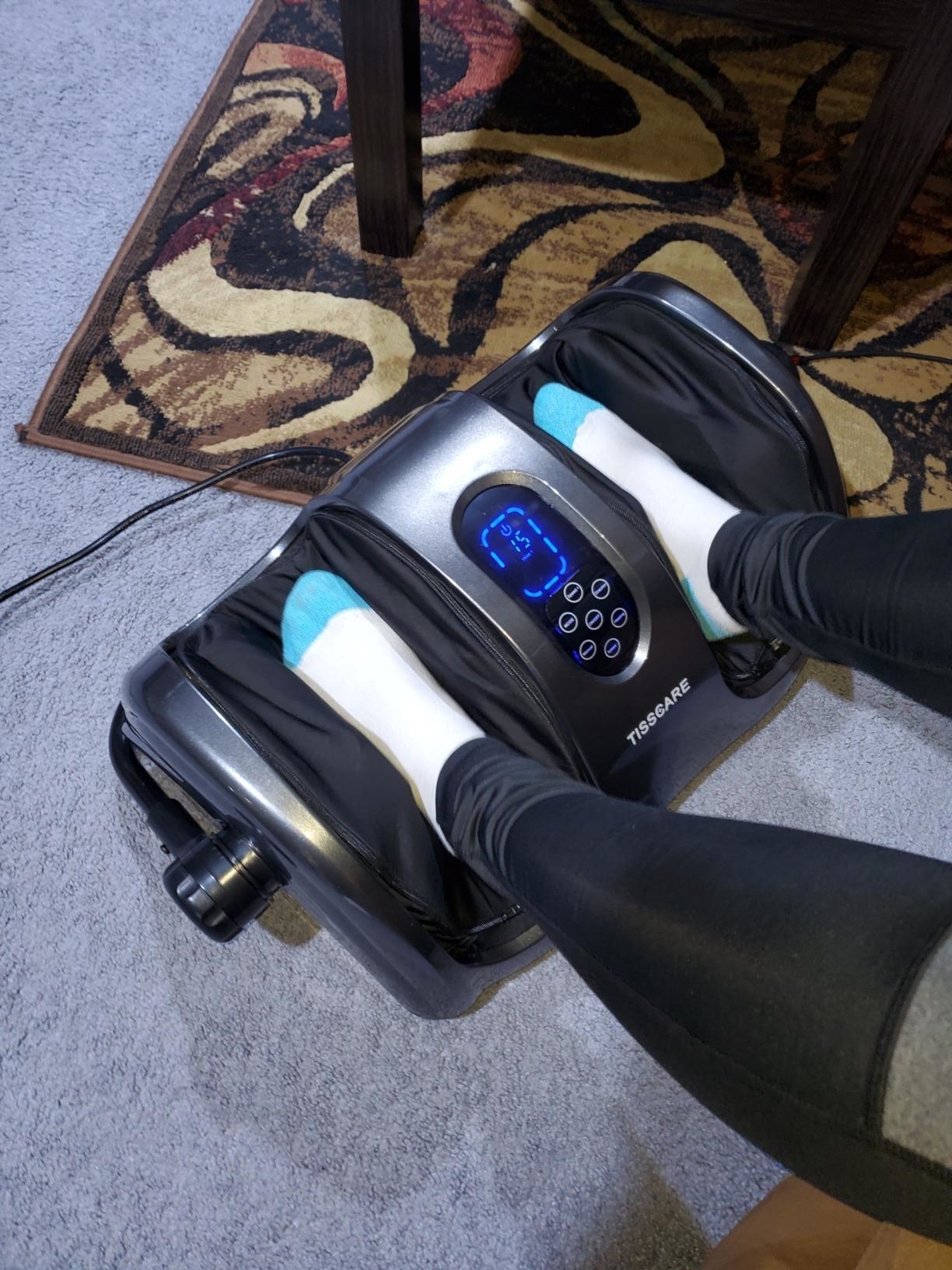 reviewer image of them using the foot massager