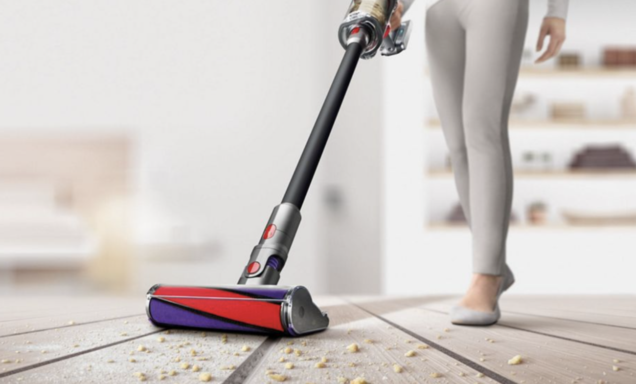 A cordless vacuum getting crumbs off the floor