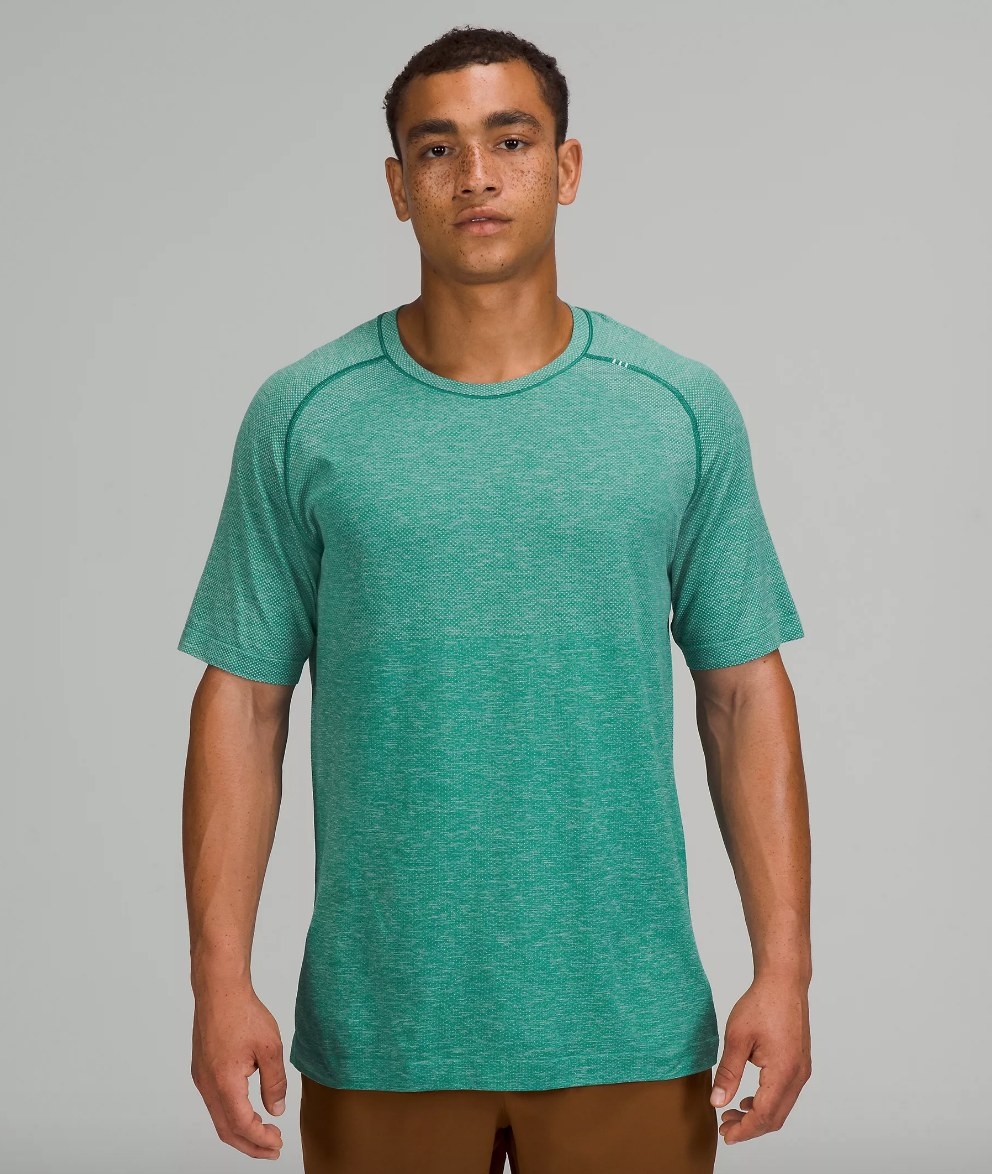 Model wearing teal ventilated shirt with brown pants