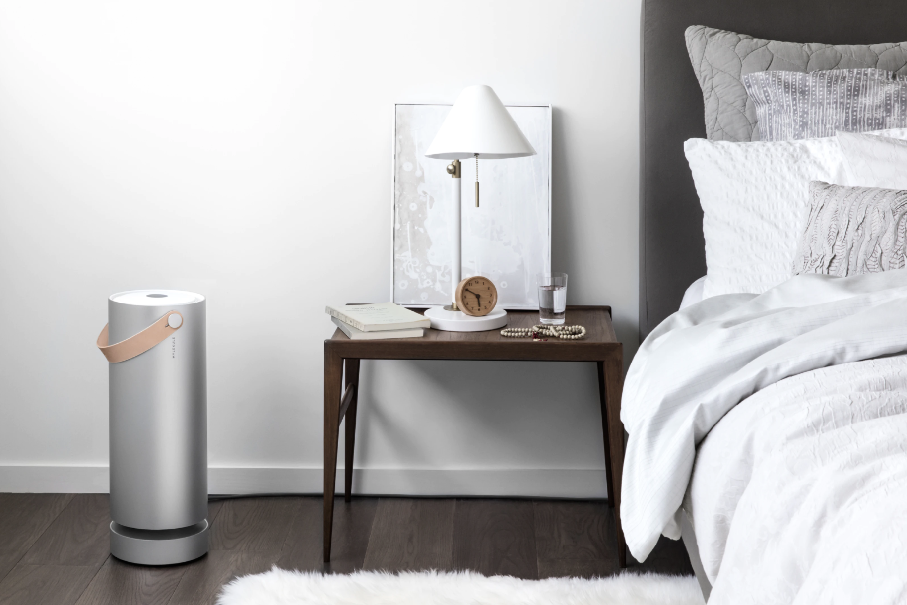 The air purifier beside a bedside table