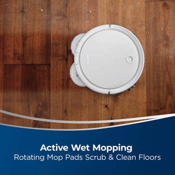 the product's rotating mop pads cleaning a wood floor