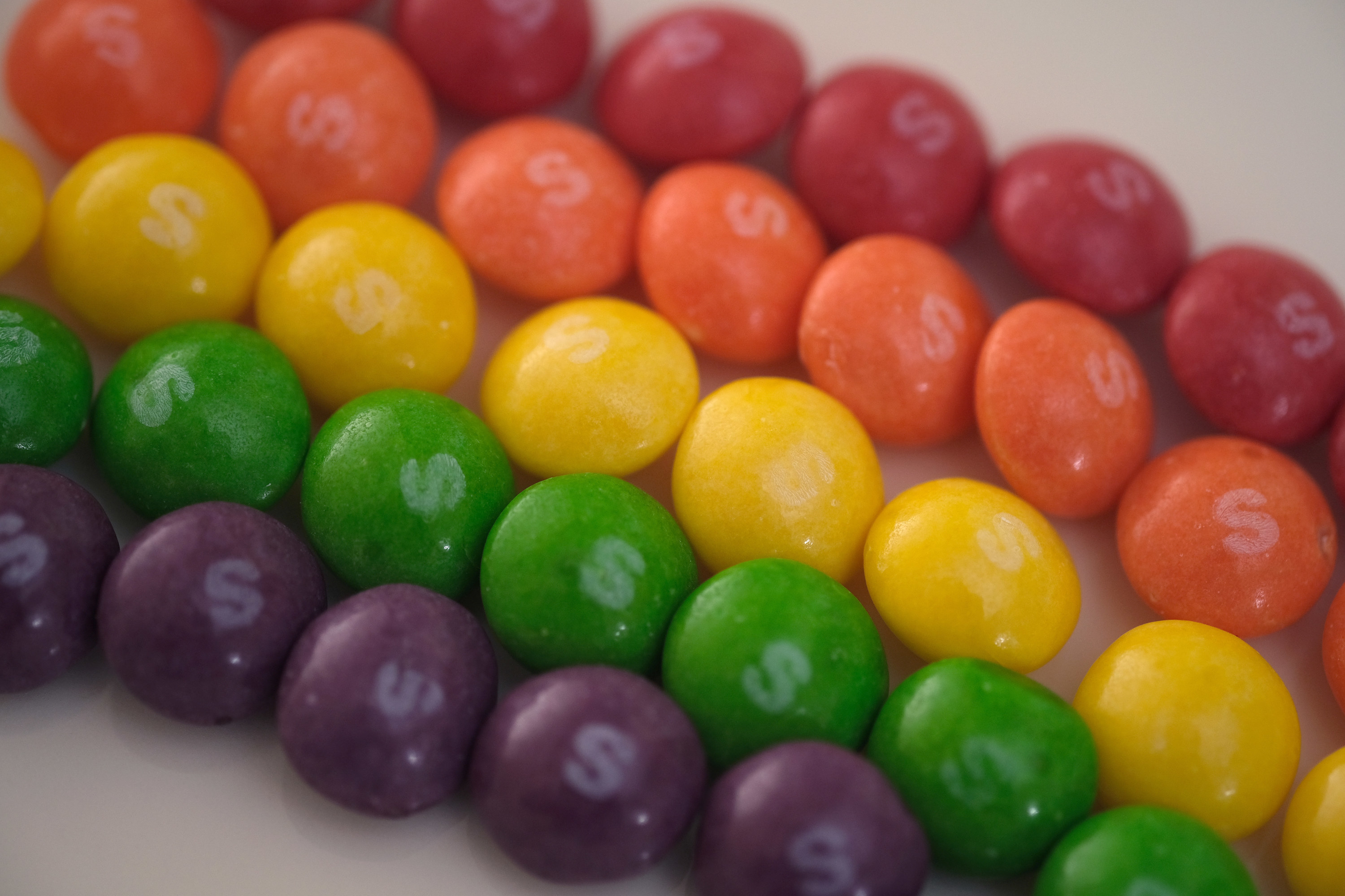 Skittles arranged in a rainbow pattern