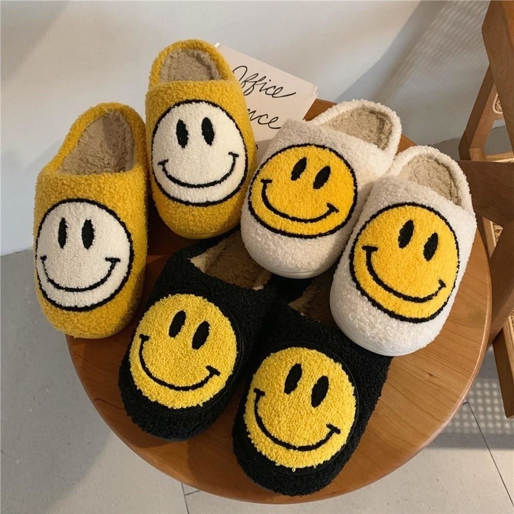 slippers in red, white, and black, with smiley faces on them