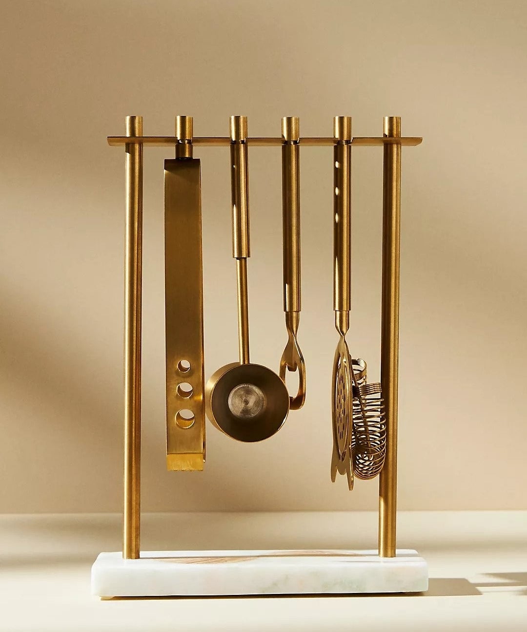 marble base and gold frame holding matching gold bar tools