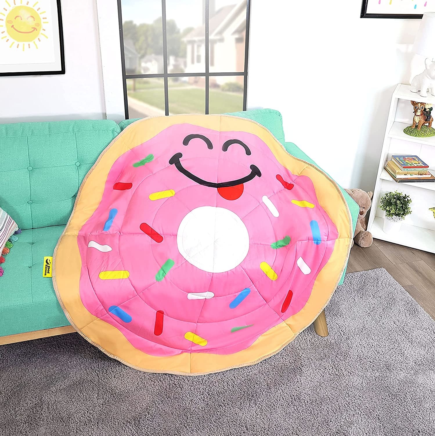 Circular blanket that looks like a pink frosted donut with sprinkles