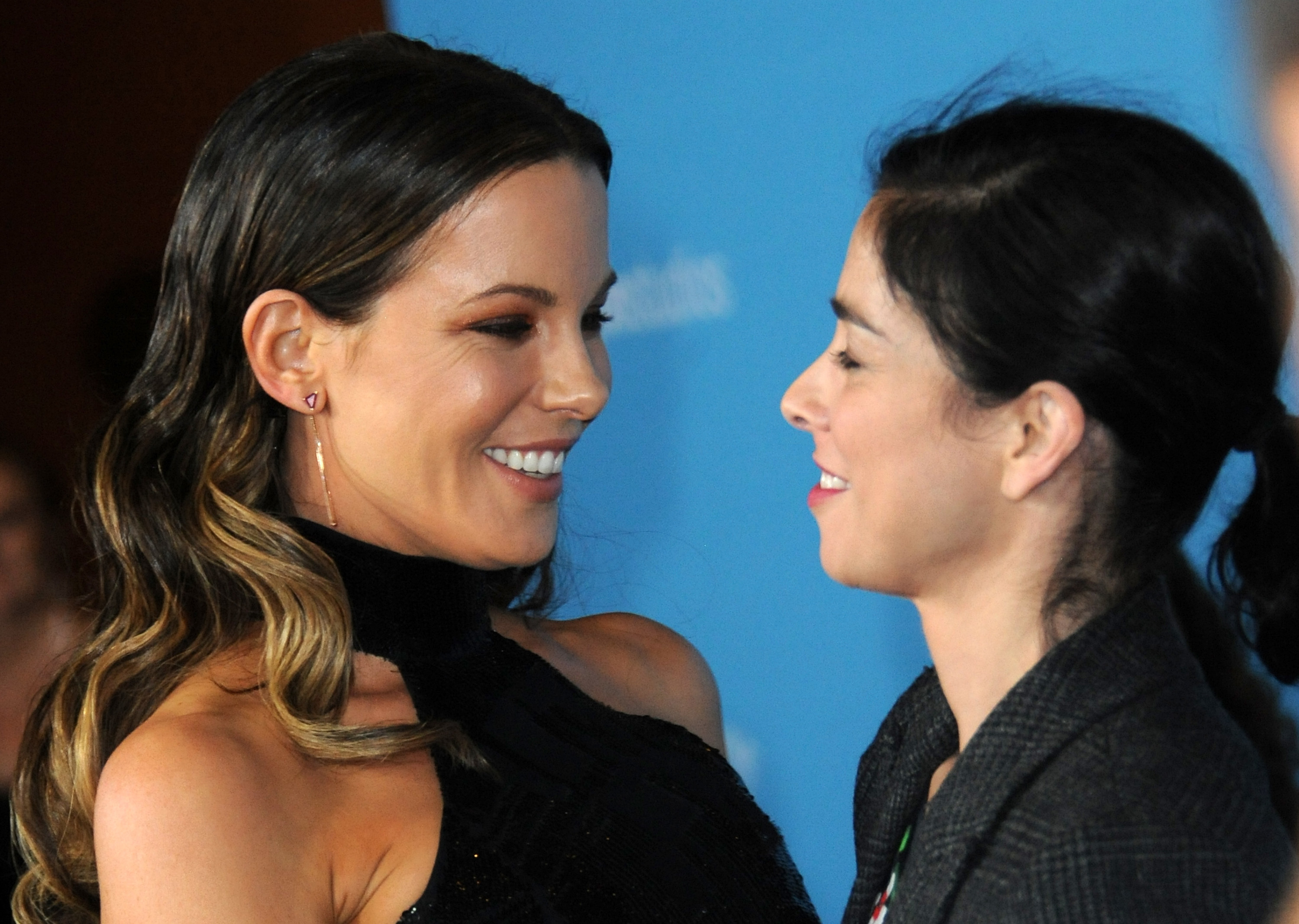 Kate Beckinsale and Sarah Silverman smiling at each other
