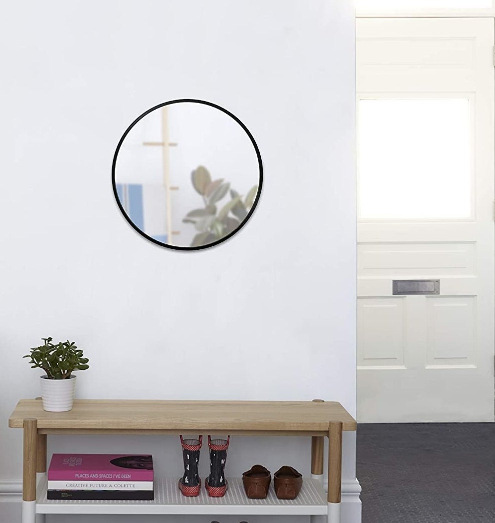 The mirror above a bench in an entryway