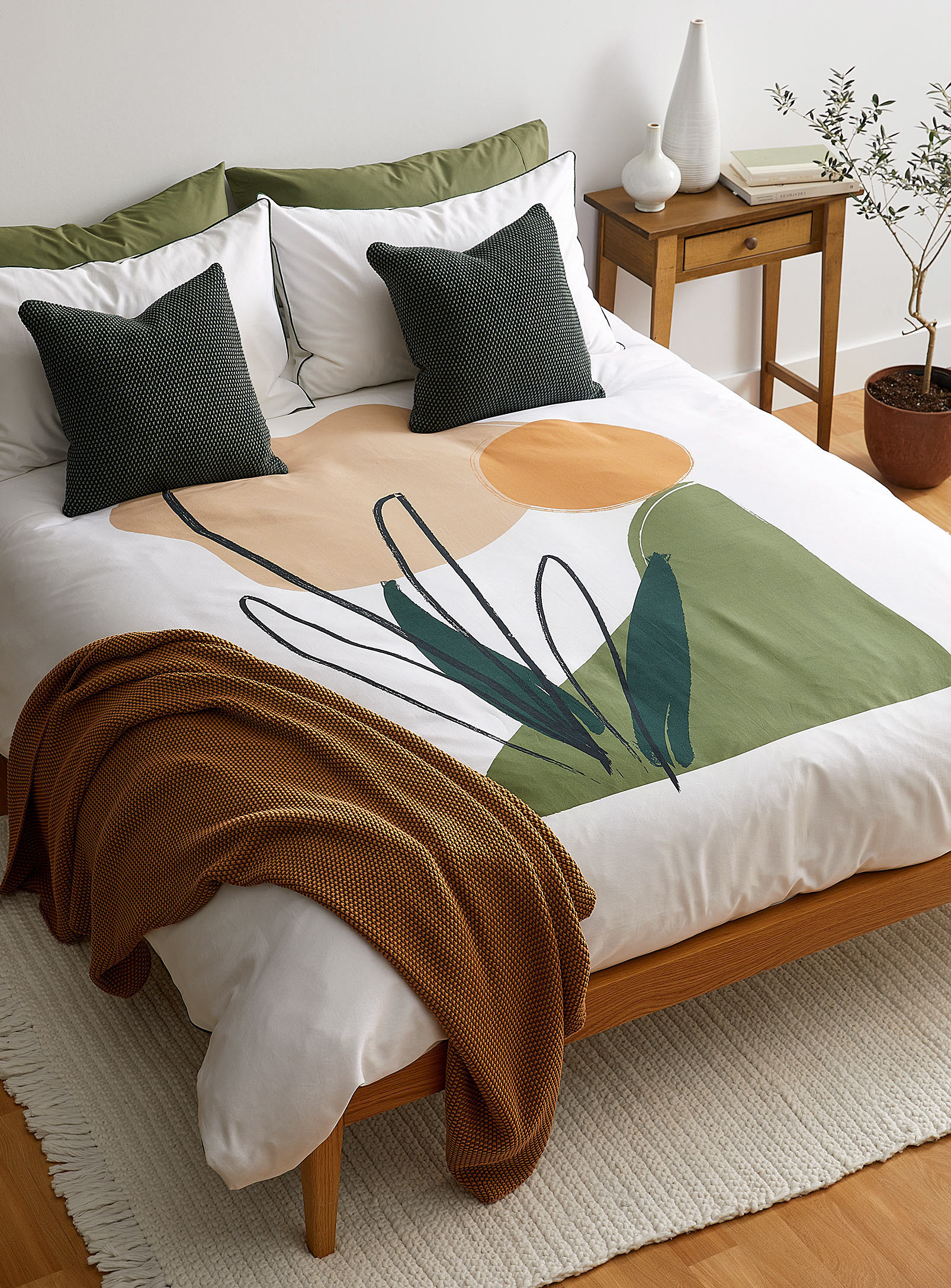 A duvet on a bed with tons of pillows on it