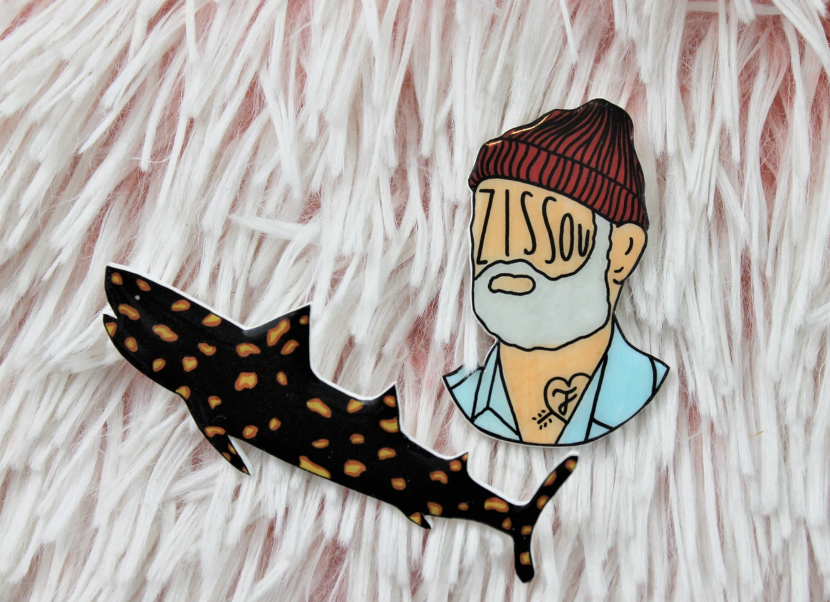 a jaguar shark pin and a steve zissou pin
